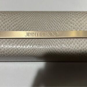 Authentic Jimmy Choo sunglasses case in a beige snakeskin-textured finish.